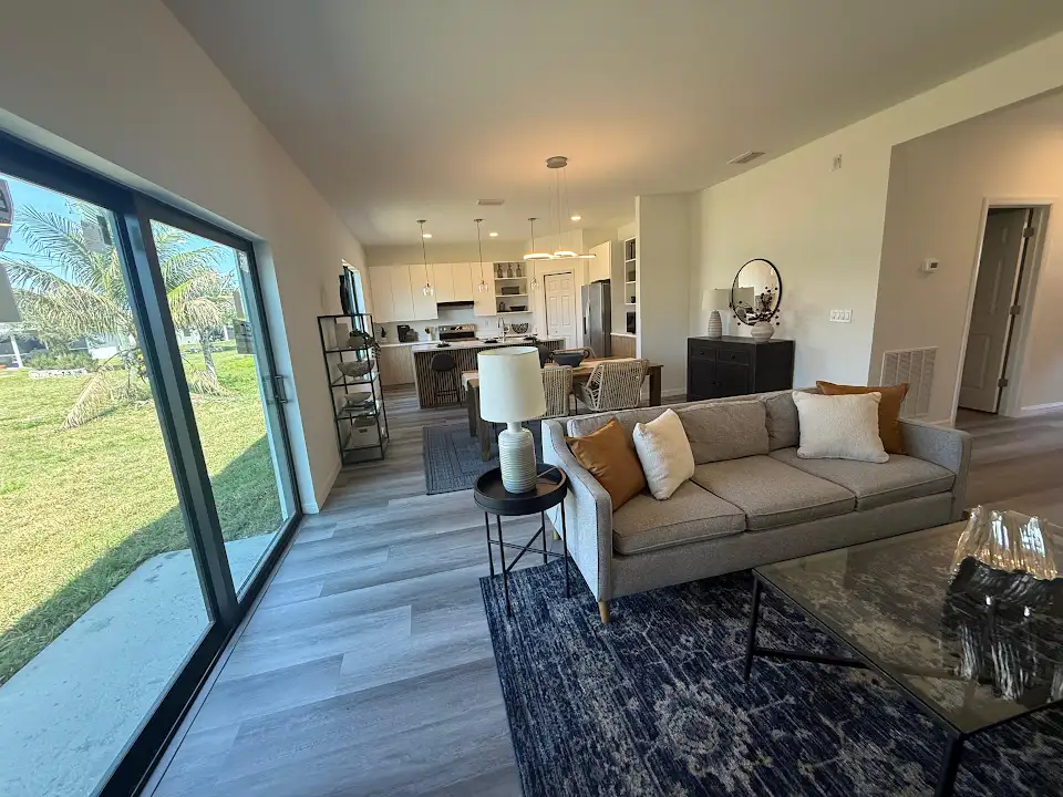 Completed open-plan living room renovation with large sliding glass doors